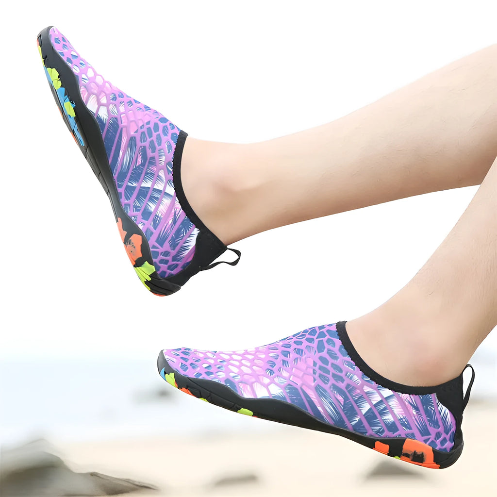 Blue Lycra beach wading shoes with EVA midsole on a sandy beach