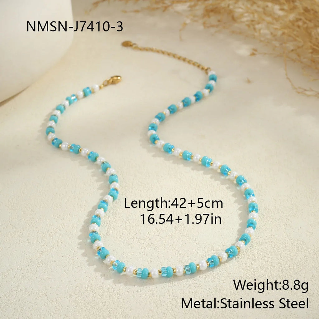 18K gold plated stainless steel chain necklace with pink electroplated resin bead pendant on white background
