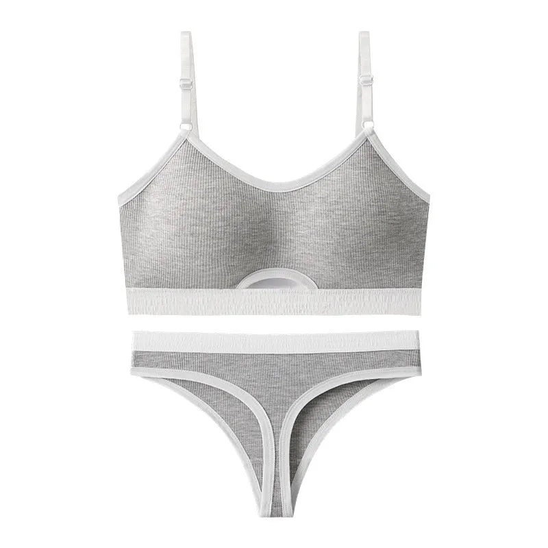 Women's contrast back sports bra vest and briefs set in black with underwire and padding.