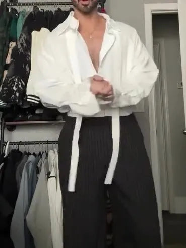 White oversized tie-front shirt with relaxed fit, open collar, and regular-length cut on a plain background