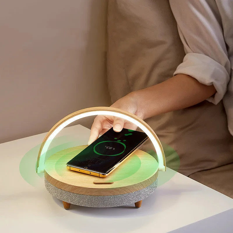 Wireless charging LED night light with Bluetooth speaker and phone holder in compact bedside design