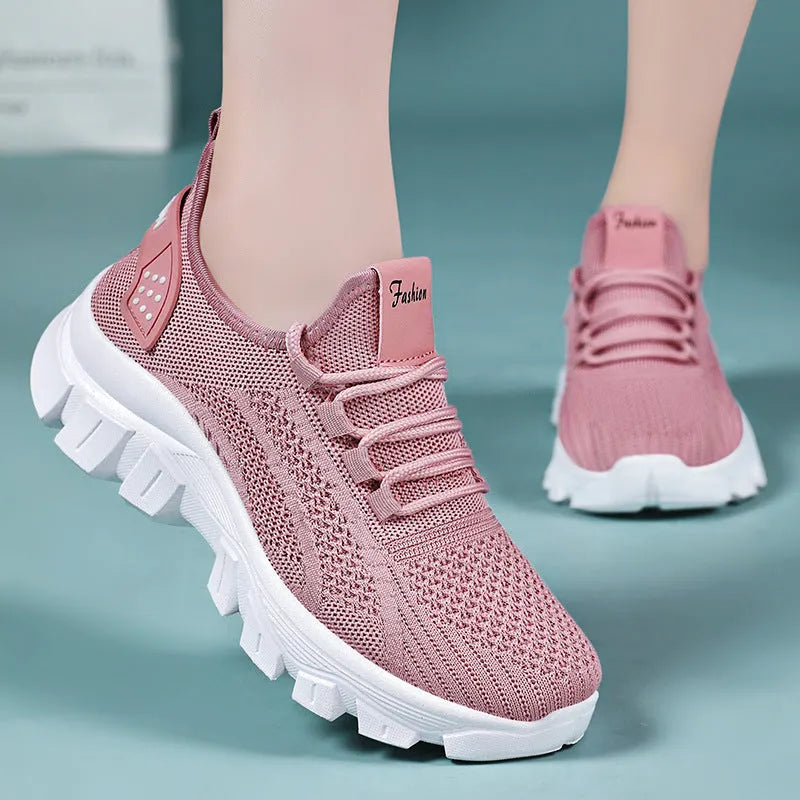 Women's white Flyknit running sneaker with thick PVC sole and lace-up front on a neutral background.