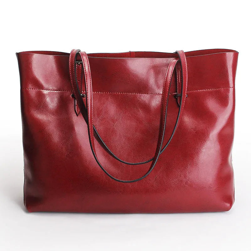 Brown wax cowhide leather handbag showing internal compartments and crossbody strap