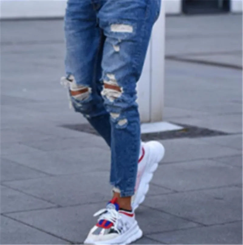Deep blue men's jeans with hole detailing made from cotton fabric