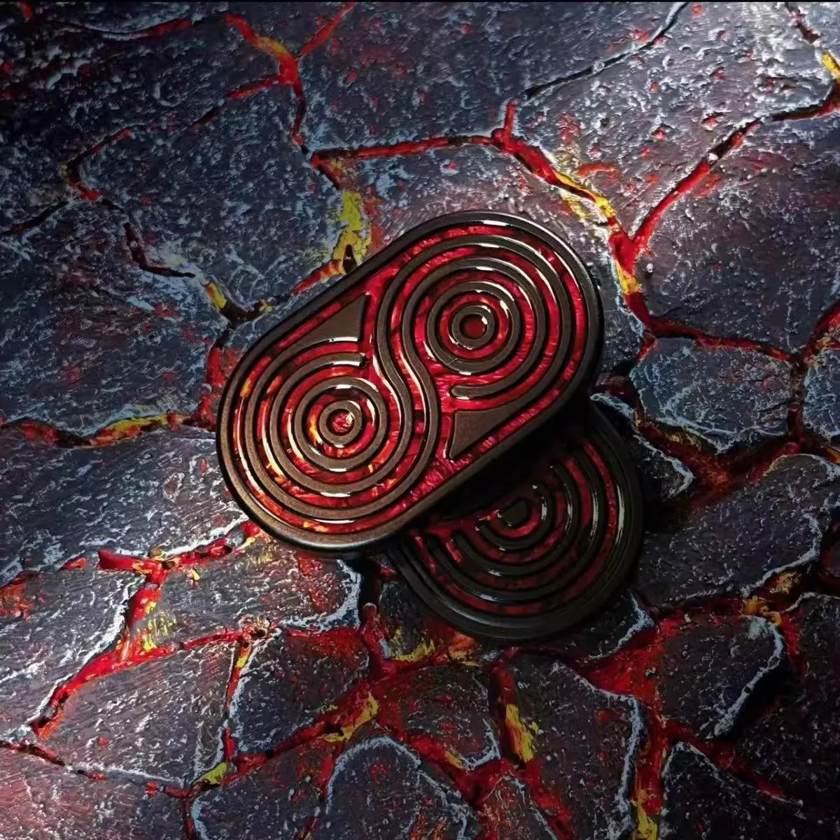 Stainless steel EDC hand push coin in agate red colour on plain background
