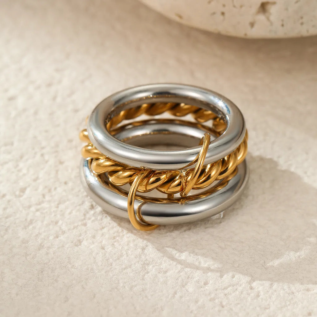 Gold plated exaggerated stackable ring for women on a hand, showing layered jewellery style.