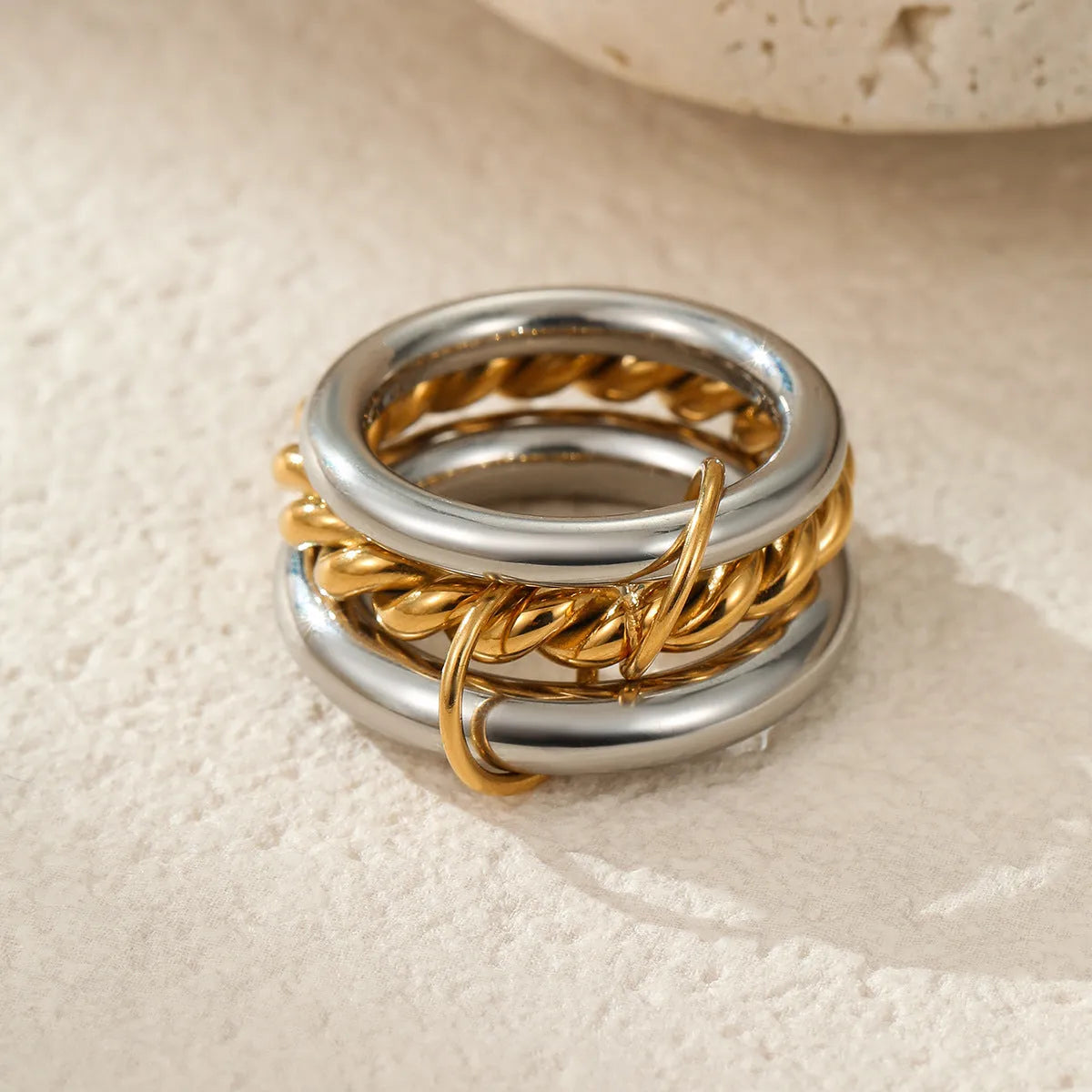 Gold plated exaggerated stackable ring for women on a hand, showing layered jewellery style.
