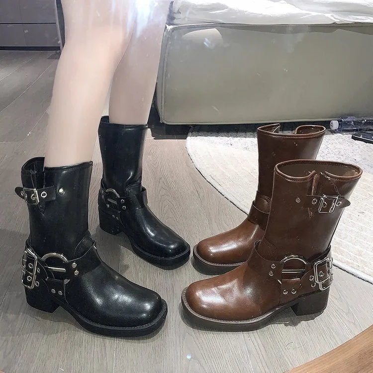 Women's black platform boot with belt buckle detail on middle calf.