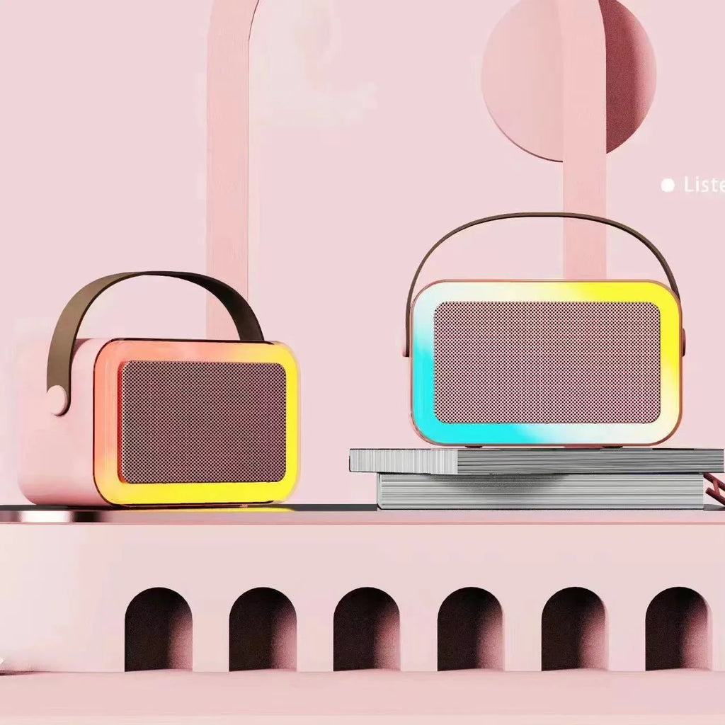 White, pink, or sky blue portable Bluetooth speaker with built-in karaoke microphone and coloured LED lights.
