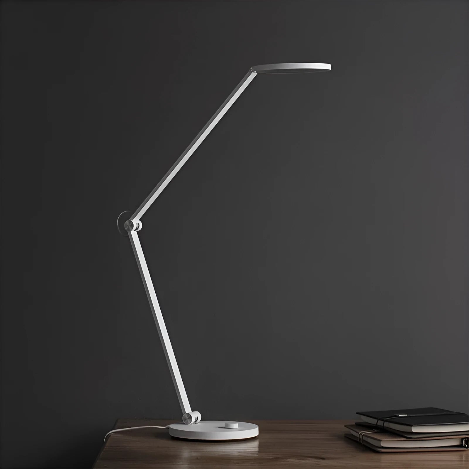 ProLED folding desk lamp with adjustable arm and modern design on a wooden desk