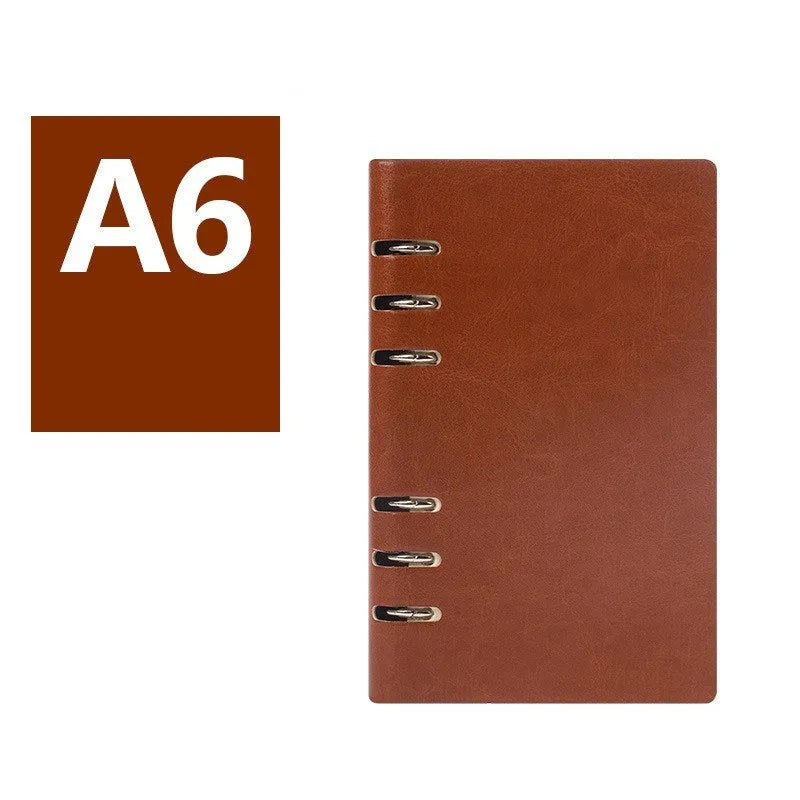 Loose-leaf business notebook with imitation leather cover in multiple colours, open to show beige paper.