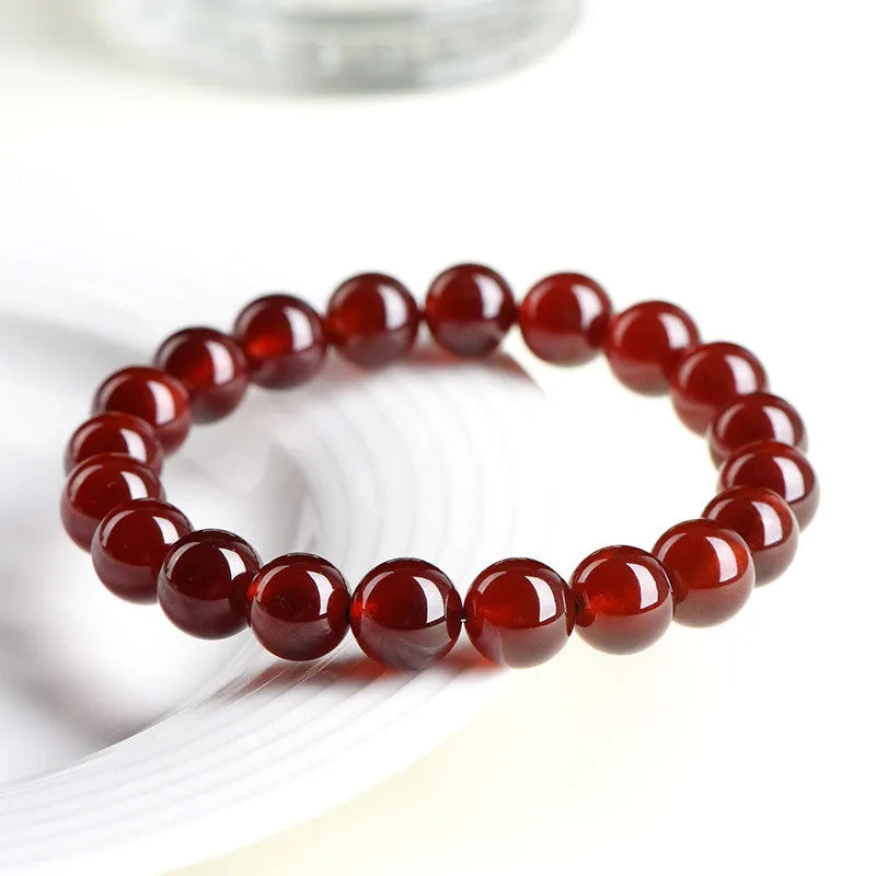 Natural orange red garnet ball crystal bracelet with Ruyi design in retro unisex style.