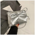 Women's black PU leather crossbody bag with horizontal square shape and visible sewing details