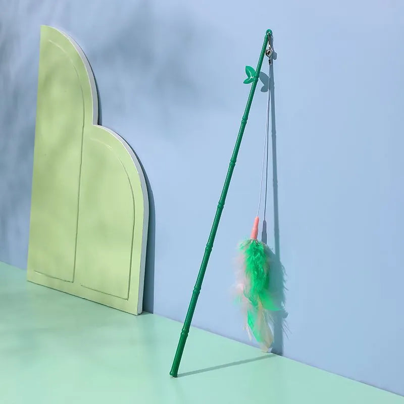 Green interactive cat feather wand toy with bell attachments for feline exercise and training