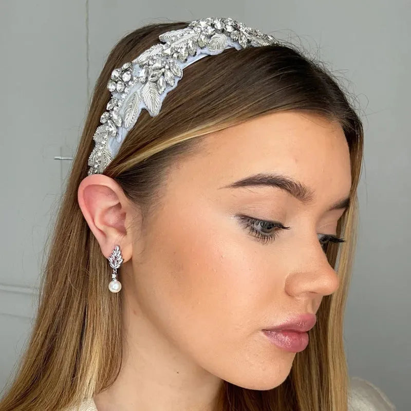 Geometric shaped floral earrings with micro zircon inlays, shown in a gold-tone plated finish.
