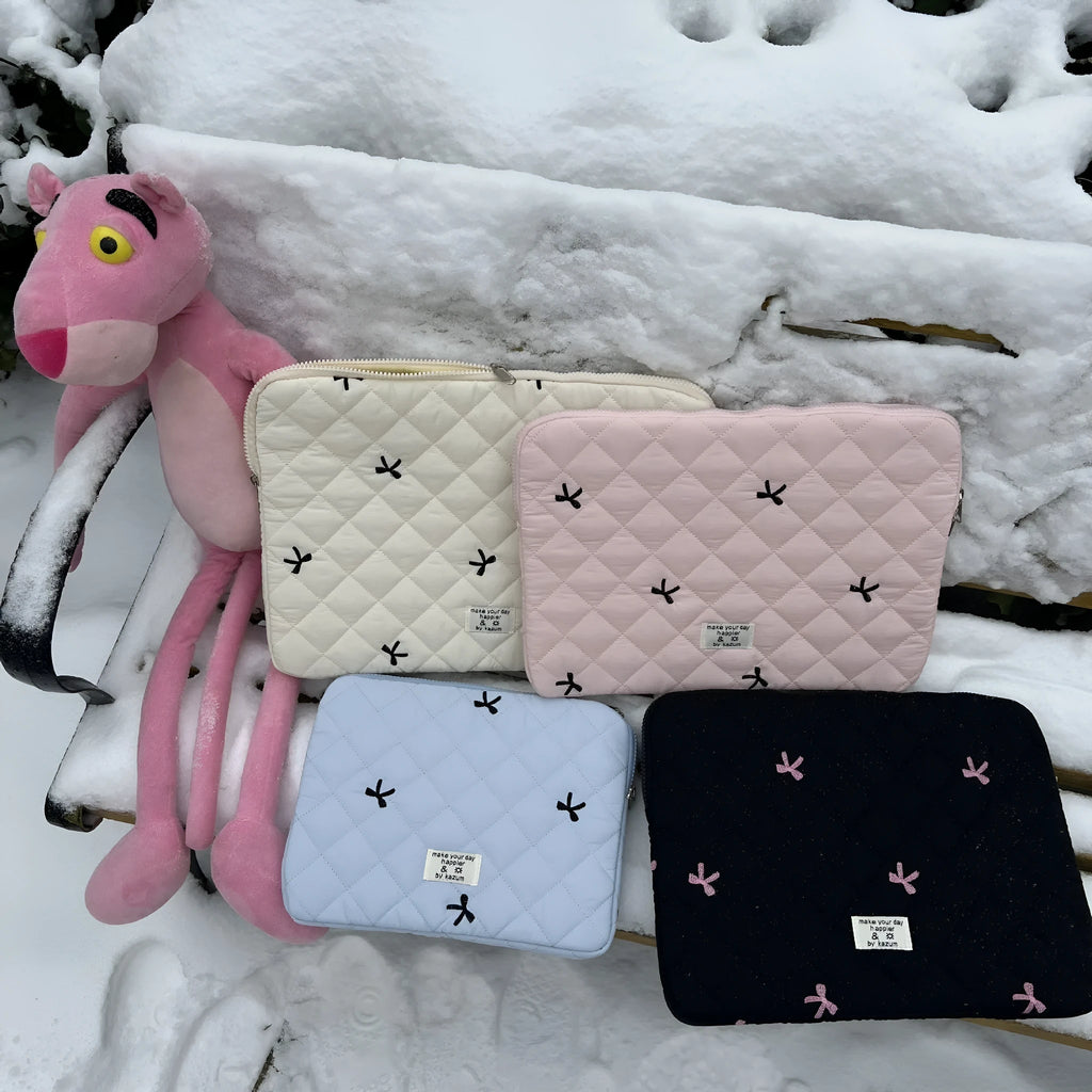 Nylon laptop storage bag with an embroidered rhombus bow in light pink colour.