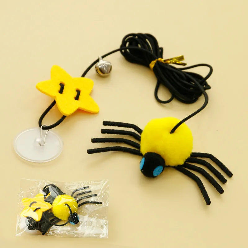 Red and yellow cat hanging door toy with elastic rope, feather, bell, and spider decoration.