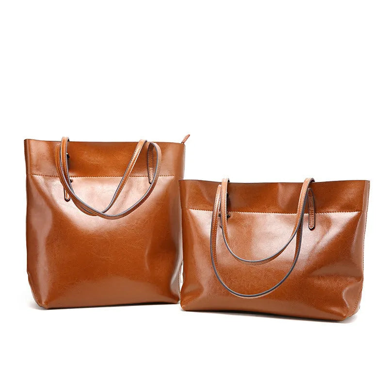 Brown wax cowhide leather handbag showing internal compartments and crossbody strap