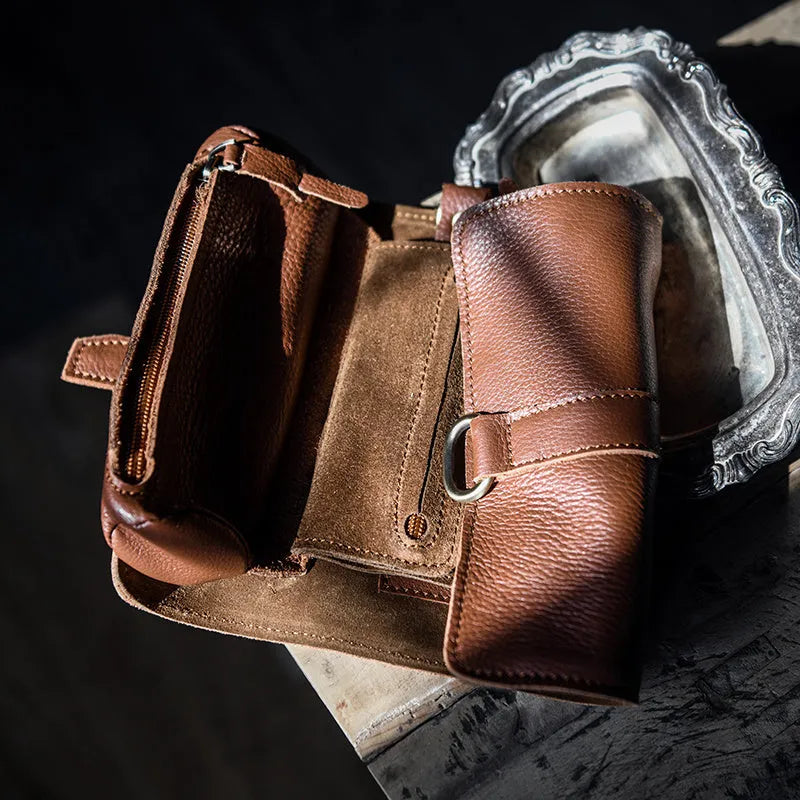 Handmade brown cow leather vintage wallet with tape closure, lying flat.
