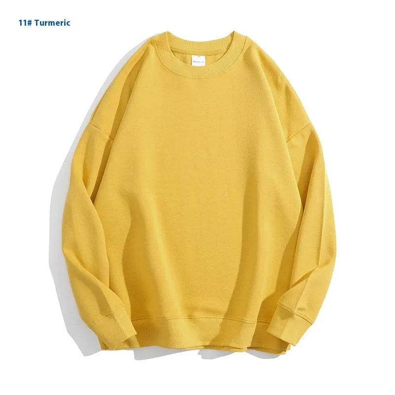 A loose-fitting, off-shoulder cotton sweater in a solid colour with long sleeves and a round neck.