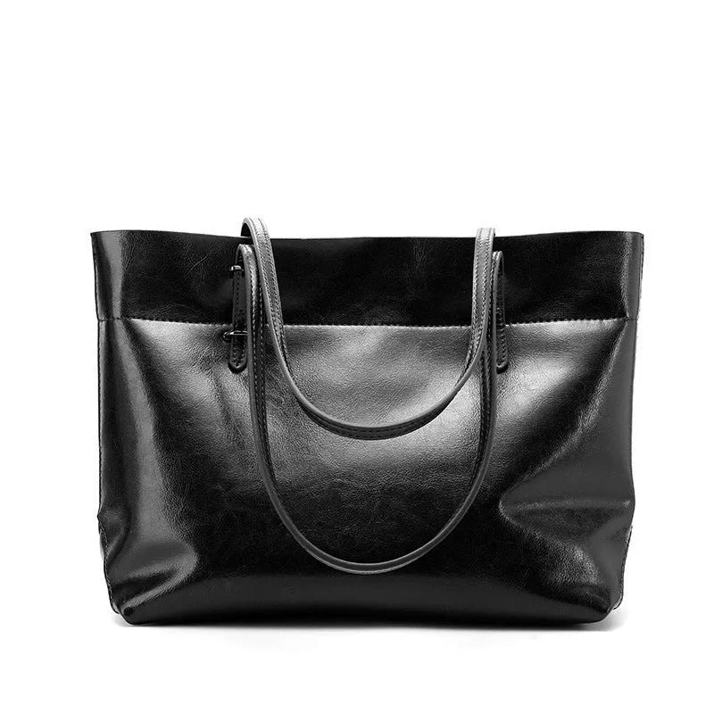 Brown wax cowhide leather handbag showing internal compartments and crossbody strap