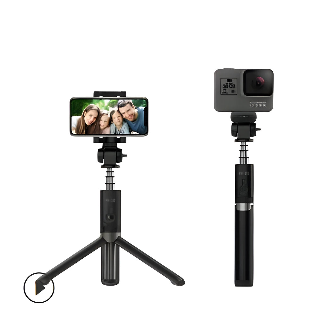 Aluminium Bluetooth selfie stick with tripod base and remote control next to a smartphone.