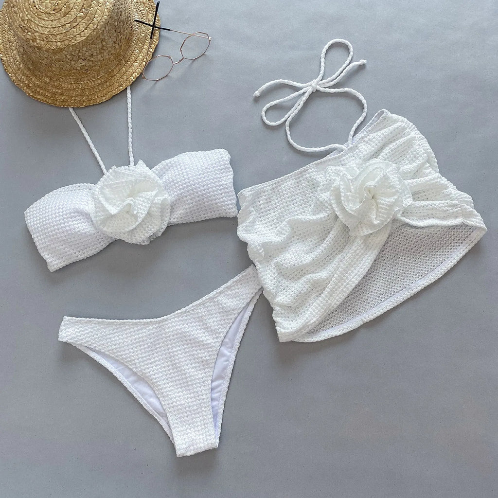 Women's purple and white 3D flower split three-piece bikini set with skirt, bra, and briefs.