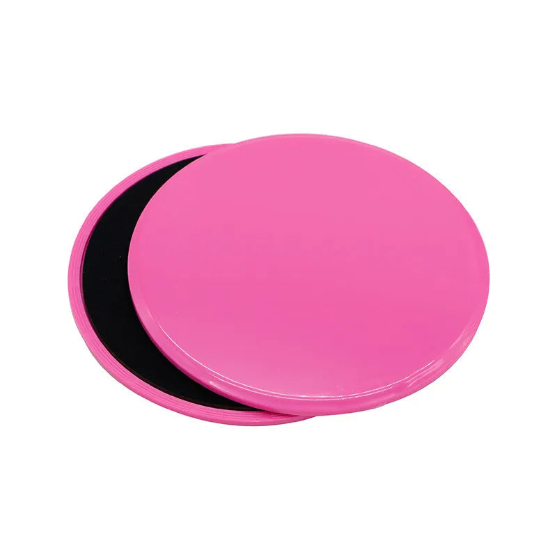Two pink fitness sliding discs on hard floor showing double-sided texture, 18x18x2cm