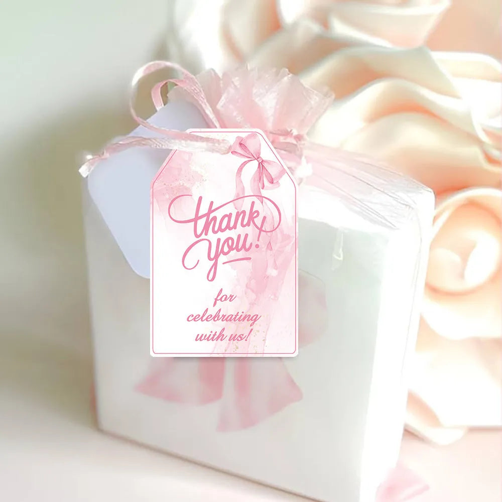 Set of 60 bowknot-shaped paper gift tags with natural hemp rope for birthday parties in three styles.