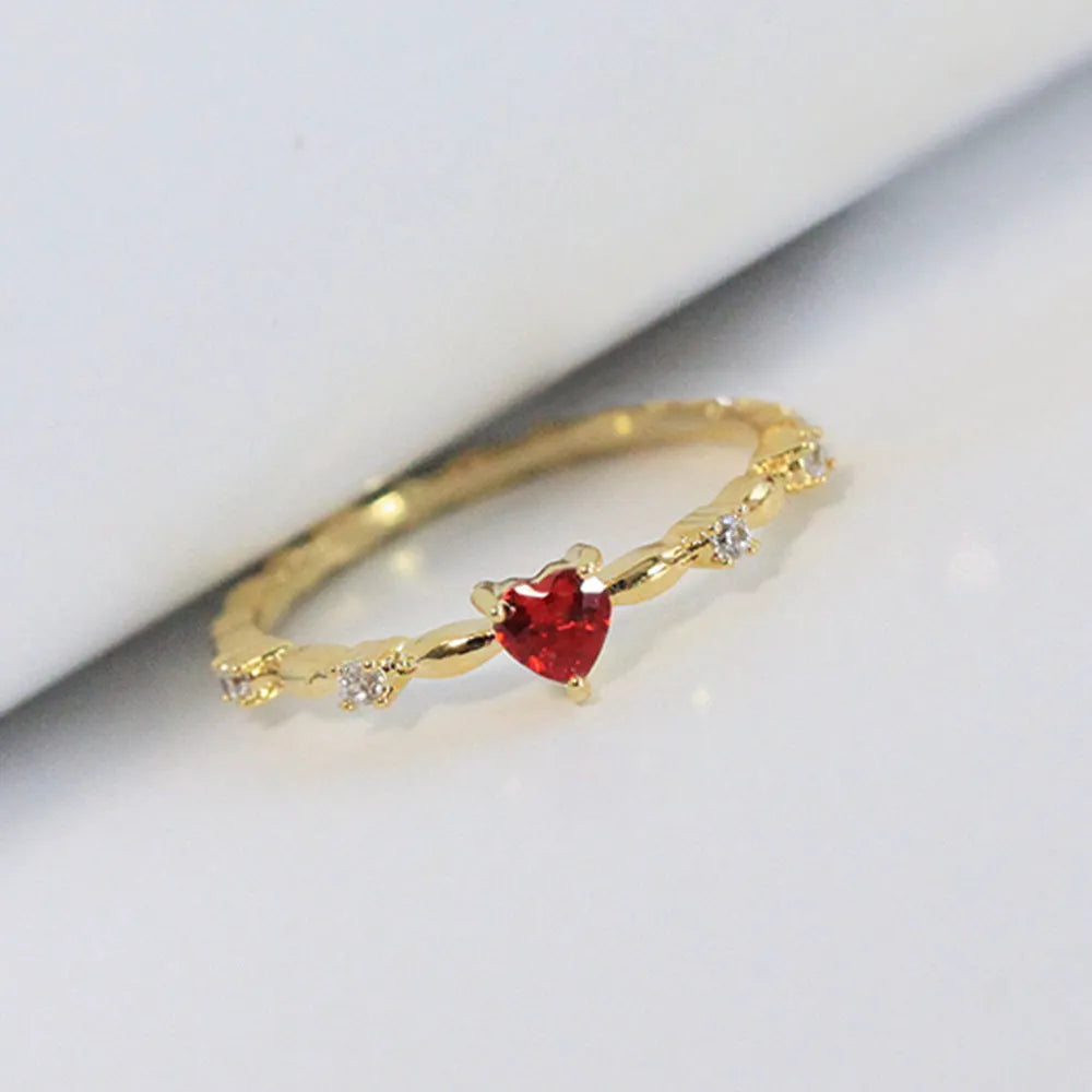 Gold and silver electroplated fashion ring with a peach heart charm and zircon stone.
