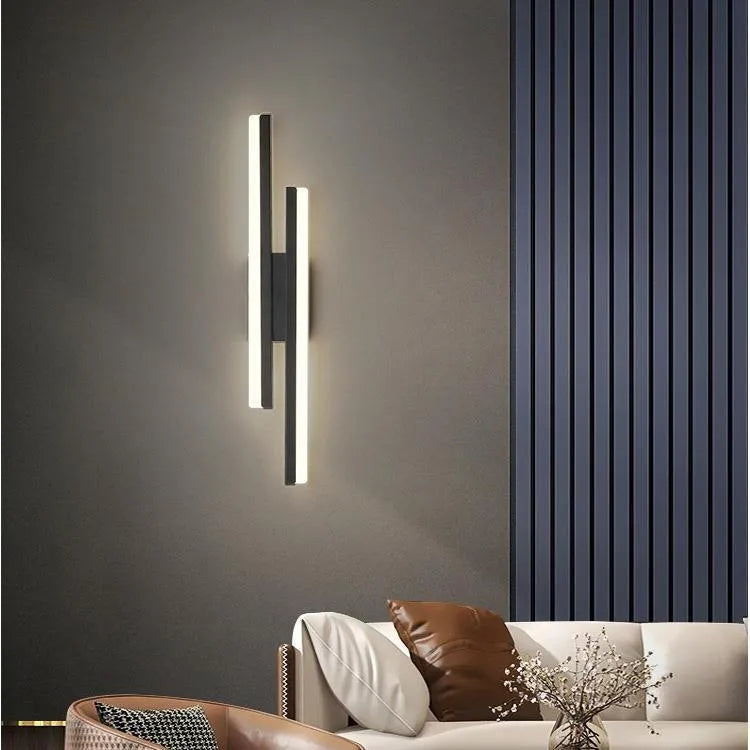Modern Scandinavian minimalist LED wall light with acrylic shade in black or gold finish.