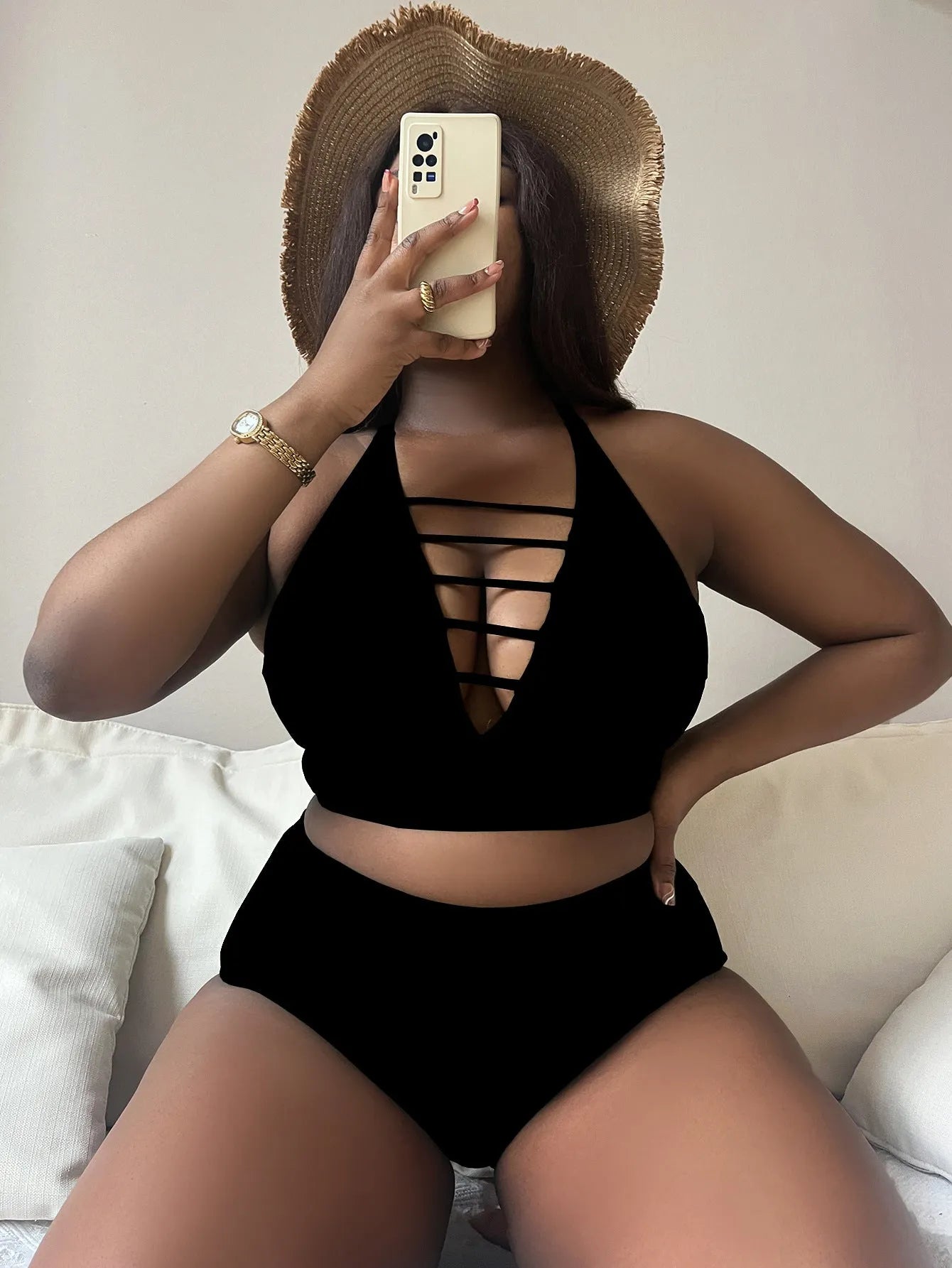 Plus size black halter bikini with cross back design and high waist briefs on mannequin