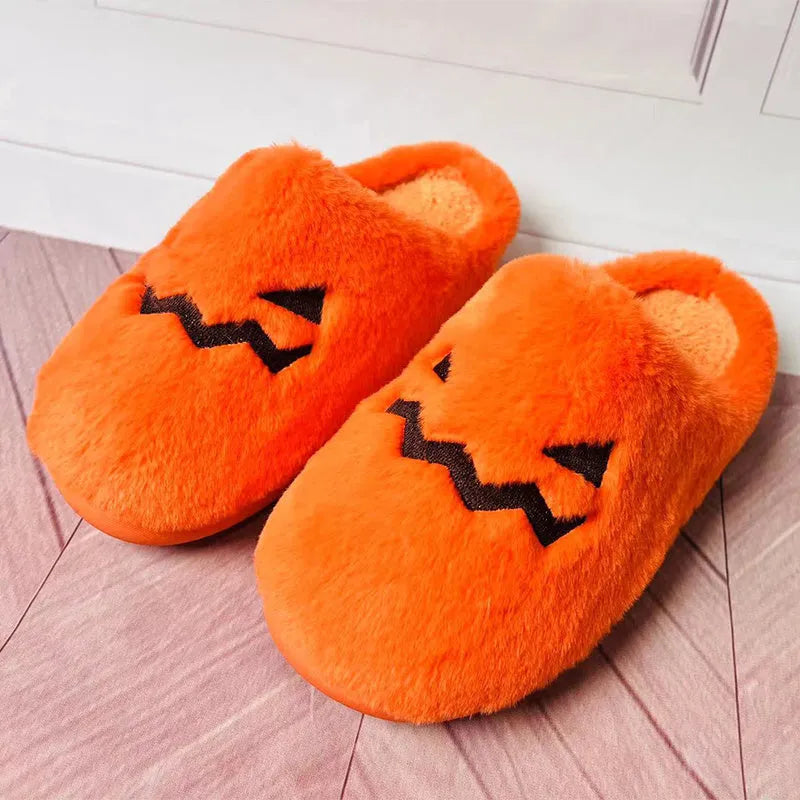 Orange coral velvet Halloween pumpkin slippers with plush lining and a grey non-slip PVC sole.