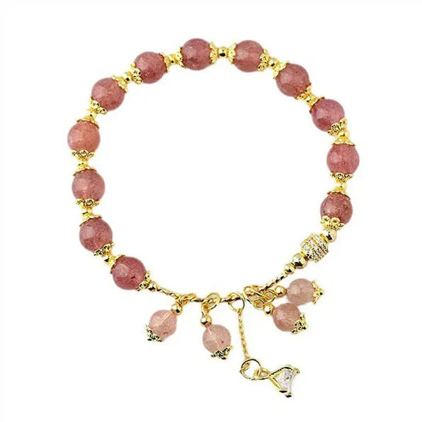 Pink women's bracelet with heart-shaped strawberry quartz crystal beads and freshwater pearl accents on a wrist.