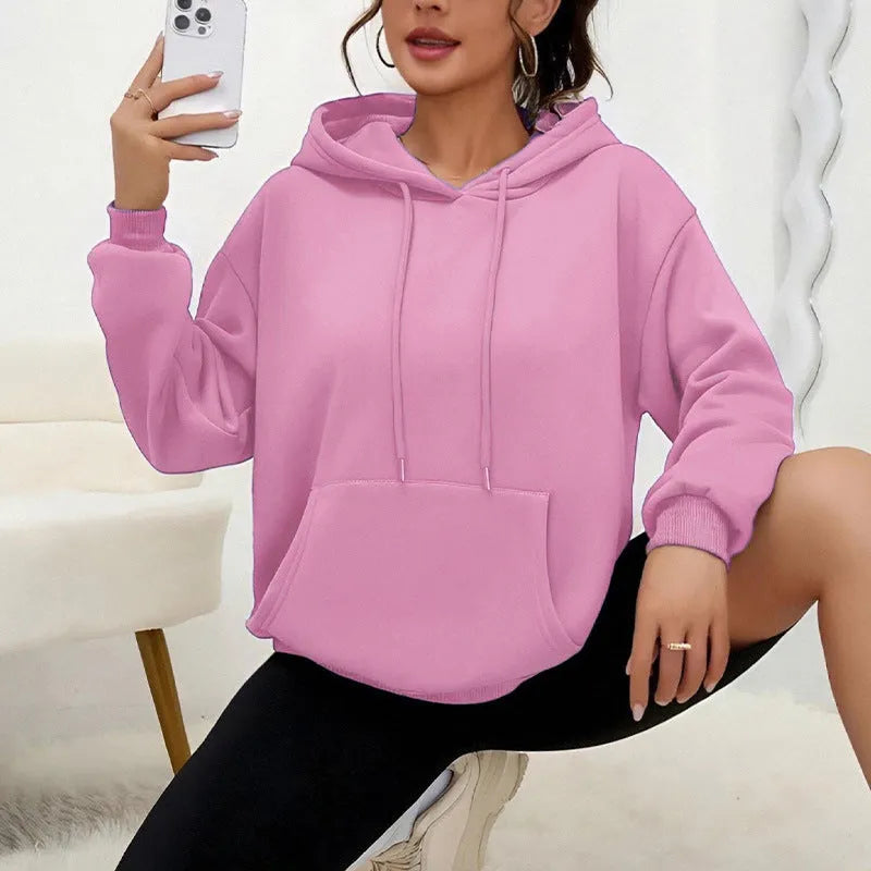 Women's loose grey drawstring pocket sweatshirt with long sleeves on a hanger.