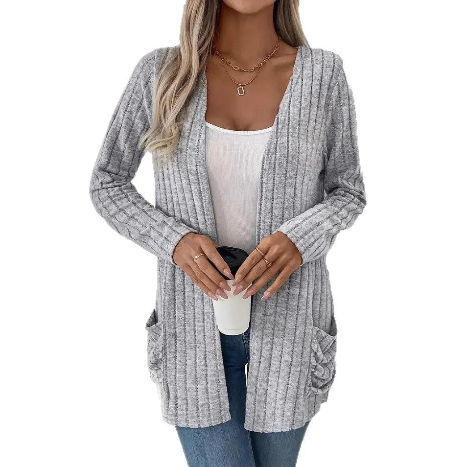 Solid colour loose fit long sleeve cardigan with front pocket in grey or black.