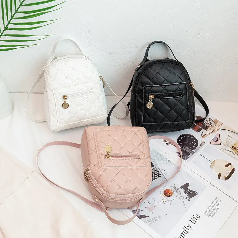 Hard white Korean style embroidered girls backpack showing sandwich pocket and soft carry handle.