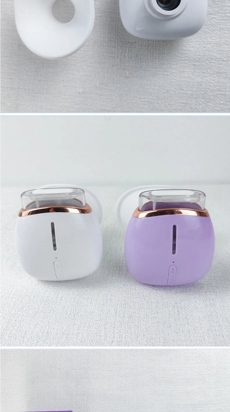 White and purple household eye humidifier with charging cable on a table.