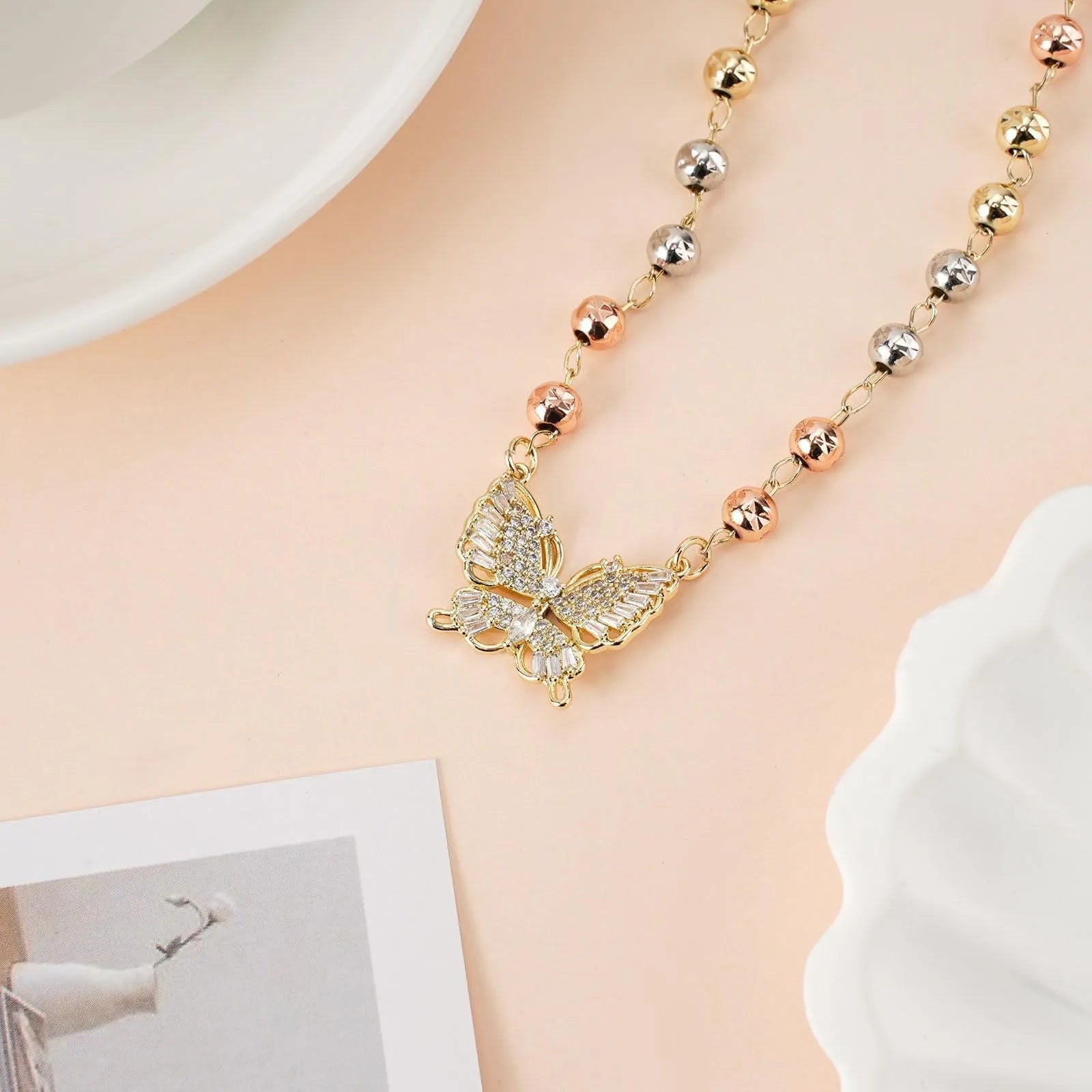 Gold butterfly necklace with zircon inlay on adjustable stainless steel chain, simple bow design for women