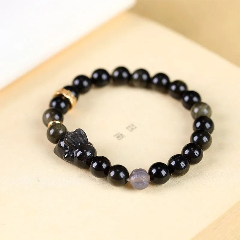 Handmade national style obsidian bracelet with a detailed lying rabbit centrepiece in jin yaoshi and grey agate.