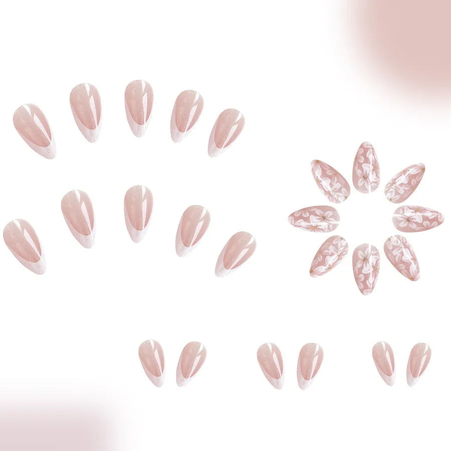 Short almond-shaped press-on nails with French manicure, flower patterns, and glitter accents in colour C625