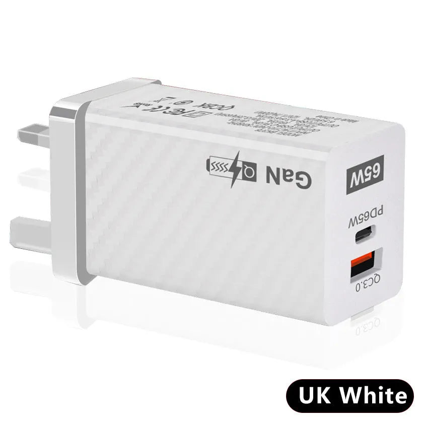 White gallium nitride GaN 65W laptop charger with USB-C port shown next to EU, UK, and US plug options