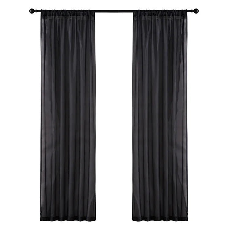Modern pure colour cotton linen curtain in black hanging vertically with light transmission visible