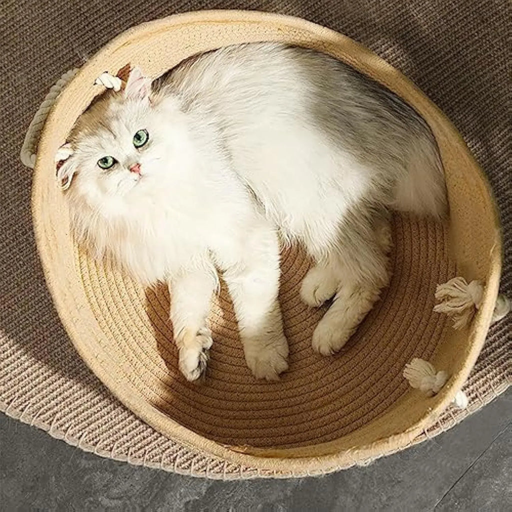 A square wicker cat bed basket with an integrated corrugated cardboard scratching panel on one side.
