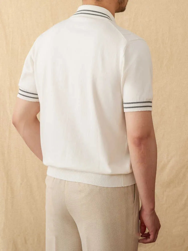A short-sleeved lapel polo shirt in a cotton blend fabric, shown in apricot colour on a hanger.