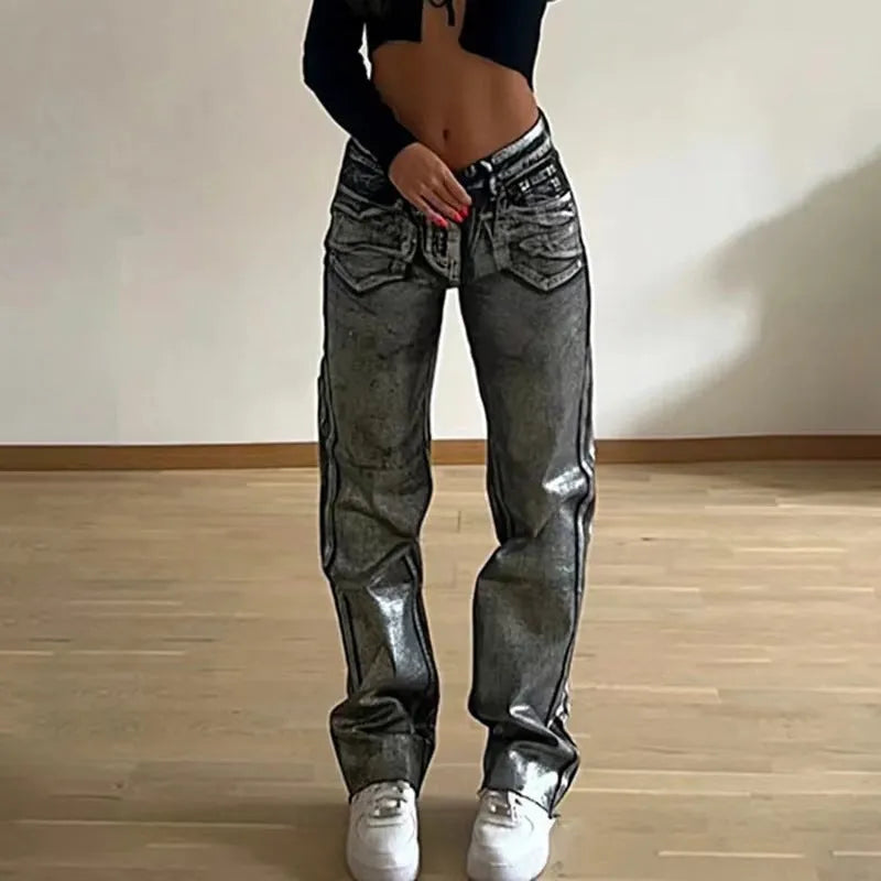 Women's high waist straight leg jeans in washed blue denim with silver contrast details