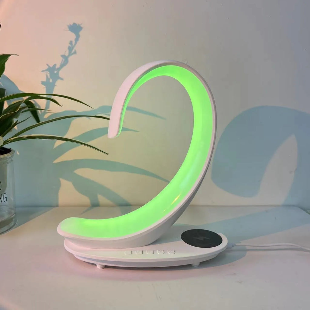 White swan-shaped desk lamp with colourful LED lights, Bluetooth speaker, and wireless charging pad.