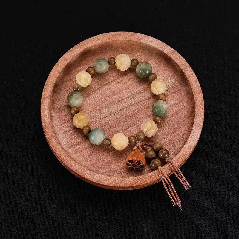 Carved pumpkin and lotus bead bracelet made from Bodhi root with white jade and aventurine details.