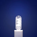 Small white USB-powered baby night light showing warm and white light options on a table