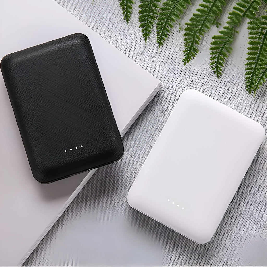 Black and white ultra-thin 10,000mAh power bank measuring 90x63x22mm with multiple USB ports